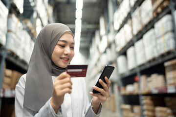 Muslim Businesswoman shopping online with a credit card at indoors