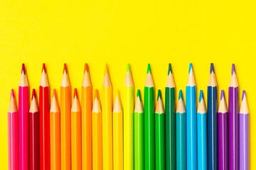 Colored pencils on a bright colored background. Equipment for coloring. Stationery for creativity.Back to school. Flatlay. Children's Creativity and Education. Rainbow.Space for text. Copy space.