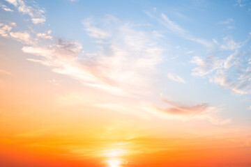 Obraz premium Beautiful , luxury soft gradient orange gold clouds and sunlight on the blue sky perfect for the background, take in evening,Twilight, Large size, high definition landscape photo