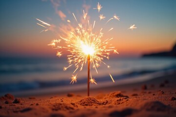 Bright burning sparklers stuck in soft sand on a calm beach at sunset, glowing with golden sparks. Clear space in the sky above for a holiday message