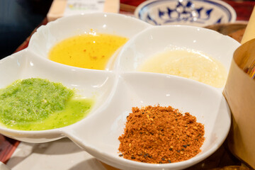 The seasonings in the four-compartment plates on the table