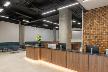 Modern hotel reception interior with decorative wooden wall