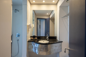 Hotel bathroom with a metal industrial-style sink cover