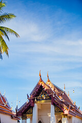 This photo captures the grand entrance of a Thai temple or palace, showcasing a magnificent golden and highly ornate archway. The intricate details of traditional Thai architecture are visible, with g