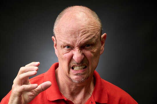 Closeup portrait of a senior man making funny faces