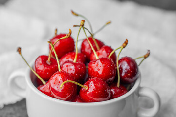 Bowl full of cherries on marble for organic snack or summer nutrition concept