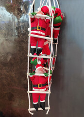 A Christmas toy in the form of Santa Claus with a white beard and glasses, wearing a hat and coat.  The atmosphere of celebration, comfort and winter fun. A holiday card for the New Year holiday.