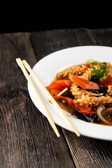 squid with vegetables on dark background. Asian food. Chinese cuisine. Seafood. Vegetables