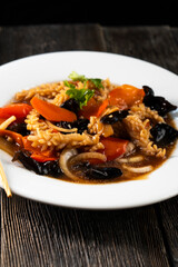 squid with vegetables on dark background. Asian food. Chinese cuisine. Seafood. Vegetables