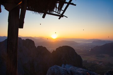 Breathtaking Stunning Sunset Over Mountain Ranges with a Cozy Rustic Shelter Awaiting Nature Enthusiasts