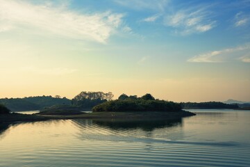 A Beautiful River Sunset, Bathed in Natural Light, Surrounded by Lush Greenery and Peaceful Reflections