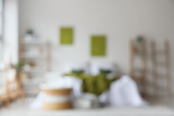 Cozy bed, shelving units and coffee table in interior of bedroom. Blurred view