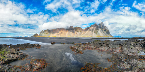 Amazing sunny day and dramatic black sand beach on Stokksnes cape in Iceland