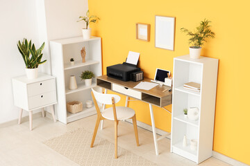 Fototapeta premium Workplace with modern printer and laptop in stylish home office
