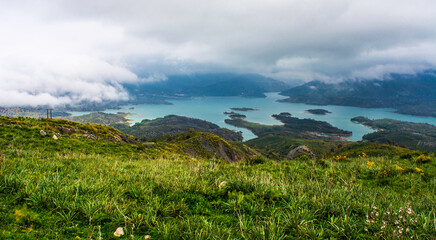 Obraz premium Beautiful landscape of lake and reflection of blue sky, clouds and mountains on surface of lake, Panoramic view of lake and snow-covered mountain and Forest trees calm in Jijel Algeria North African.