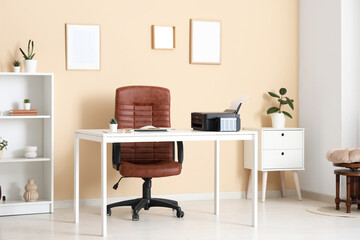 Workplace with modern printer, laptop and comfortable chair in stylish home office