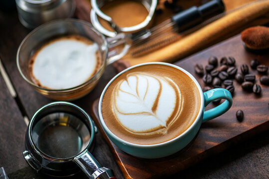 Barista Training Setup with Complete Latte Art Tools and Espresso Preparation Elements on Wooden Surface Coffee Tools Flat Lay: Organized Portafilter, Milk Jug, and Cups for Specialty Coffee.