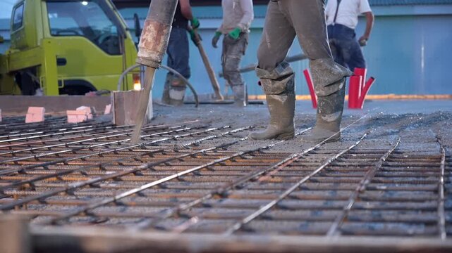 Pouring mixed concrete after installing steel reinforcement to create a house. 