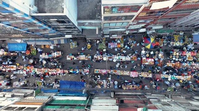 Dhaka, Bangladesh - 23 August 2025: Aerial view of the bustling Chawk Circular Road market, alive with vendors and shoppers under the Bangladeshi sun.