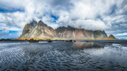 Amazing sunny day and dramatic black sand beach on Stokksnes cape in Iceland