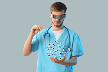 Male doctor in AR glasses with molecular model on light background