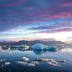 Fototapeta premium Excellent landscape with floating icebergs in Jokulsarlon glacier lagoon at sunset.