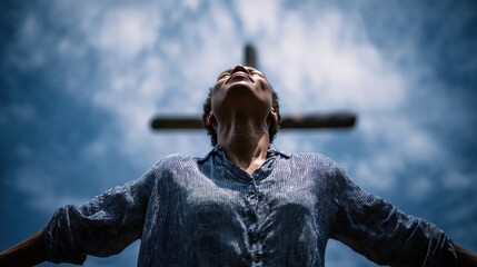 Man raises arms to sky in Worship near Christian Cross at Sunset, showing Faith and Spirituality