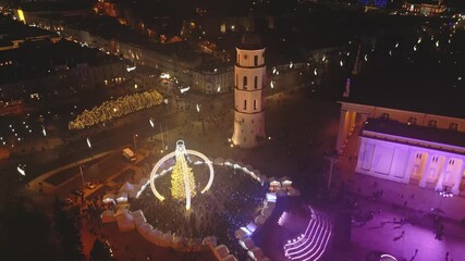 Vilnius, Lithuania - 30th november, 2024: aerial panorama cathedral square and Xmas market visitors sightseeing beautiful Xmas tree in city Vilnius - the european capital of Christmas 2025
