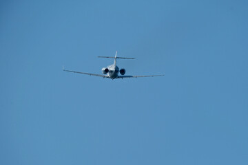 Airplane in the blue sky, close-up view of the plane. Aircraft soaring through the clear sky, detailed view of the plane.