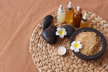 Obraz na płótnie Canvas Composition with different cosmetic products, spa stones and tropical flowers on table