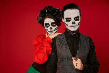 Couple enjoying heritage and tradition through sugar skull face paint for Dia de los Muertos
