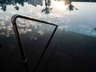 sunset reflection in hotel swimming pool