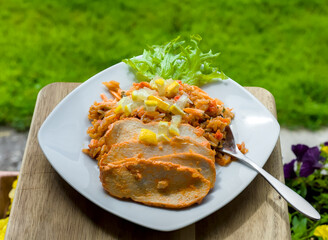 Close-up of Gourmet Marinated Spicy Piri Piri Chicken Breast with Long Grain Rice, Lemon, Roasted Red Peppers and Onions