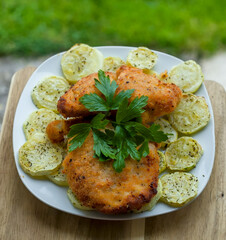 Top Down Shot of Golden Fried Chicken Breast Organic Breadcrumbs Cutlets with Roasted Zucchini and Parsley