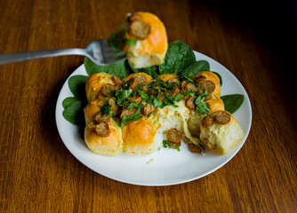 Cumberland Sliced Sausages with Garlic and Cheddar Cheese Dough Balls Pull Apart Tear and Share Bread, Spinach and Parsley, Green Outdoor Dining