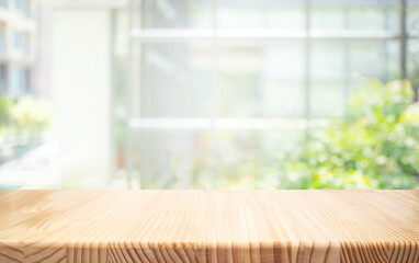 Wood table top,counter top with beautiful blur big glass wall texture with fresh garden.For...