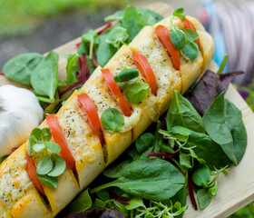 Close Up of Vegetarian Garlic Bread with Tomato, Cheddar Cheese, Basil and Spinach, Red Chard, Beetroot Salad