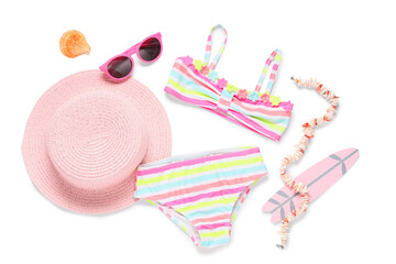 Children's swimsuit with beach accessories on white background