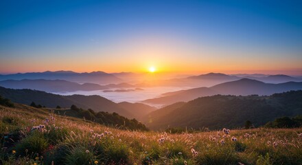 Fototapeta premium Panoramic mountain landscape with golden sunrise hues and morning mist layers