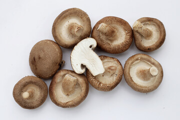 Fresh shiitake mushrooms on white background.