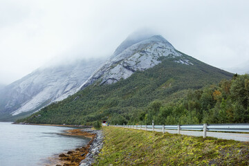 Disconnection becomes clarity as the lonely road vanishes into the tunnel beneath the cloud-covered...