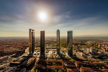 Aerial view of the Cuatro Torres Business Area skyscrapers in Madrid, Spain, at sunset