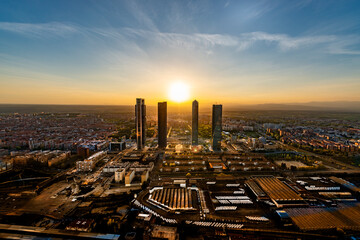 Aerial view of the Cuatro Torres Business Area skyscrapers in Madrid, Spain, at sunset