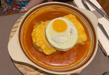 traditional Portuguese dish Francesinha from Porto served on a plate