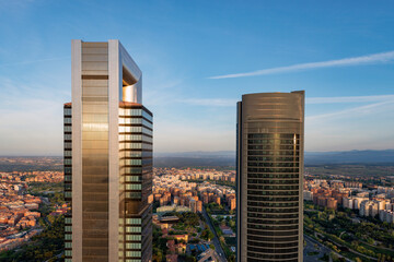 Aerial view of the Cuatro Torres Business Area skyscrapers in Madrid, Spain, at sunset