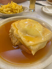 traditional Portuguese dish Francesinha from Porto served on a plate