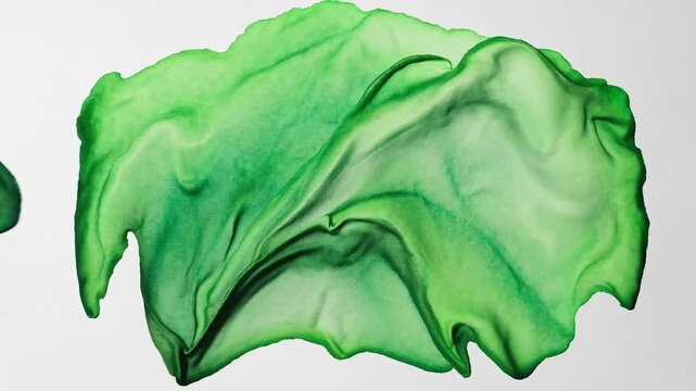 Isolated hand-crafted aqueous pigment artistic creation in emerald tones, stroke pattern suitable for typographic or emblematic use