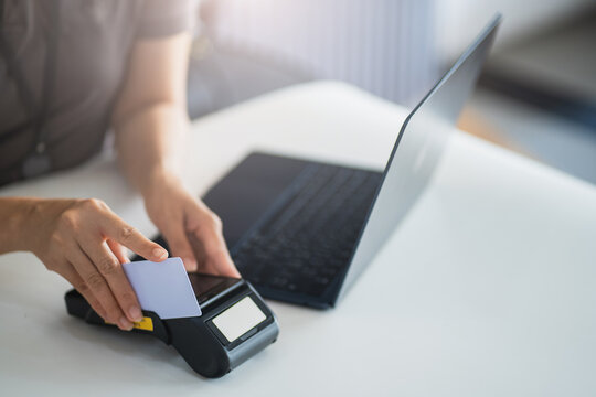 And Employee officer check verify identity ID card credit card business commercial cashier woman use card swipe machine pay for goods electronic