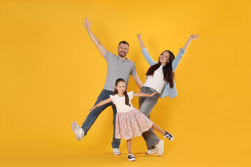 Happy family having fun on yellow background