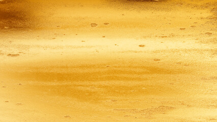 Golden plaster wall texture with subtle cracks and rough surface, elegant abstract background for...